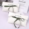 white pouch with bow tie